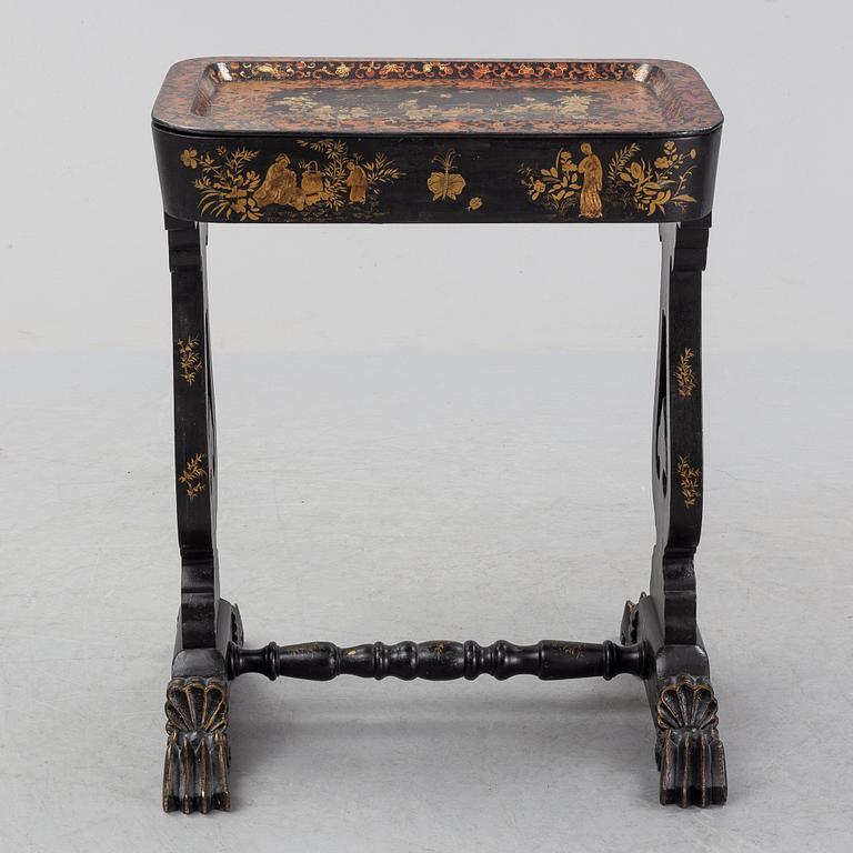 A black chinoiserie sewing table, second half of the 19th Century.