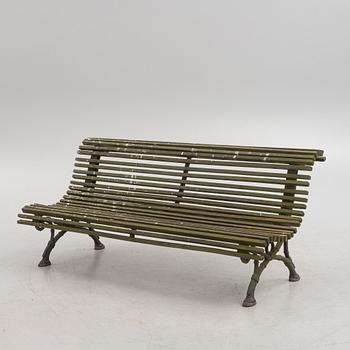 A cast iron-frame garden sofa, circa 1900.