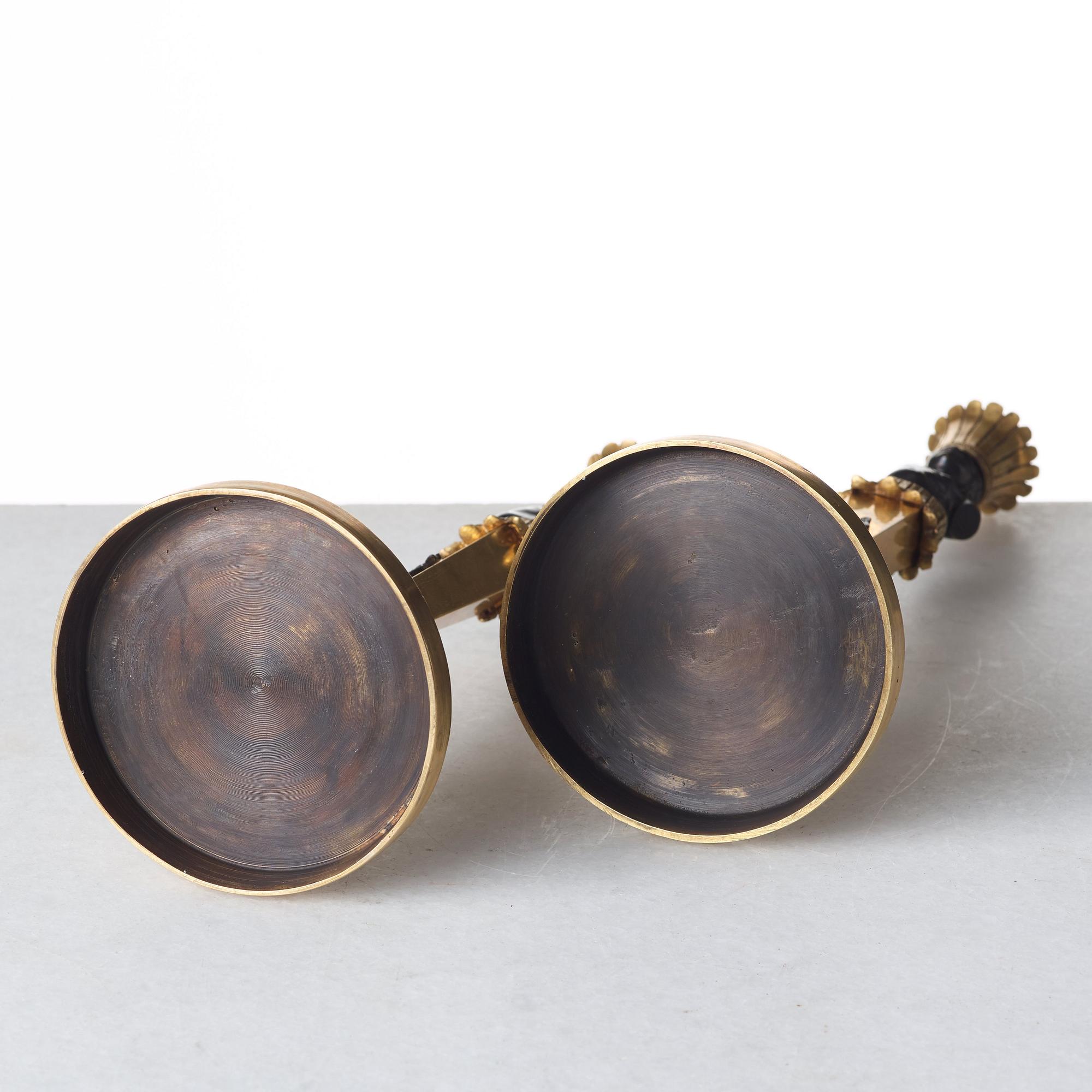 A pair of Empire style candlesticks. Late 19th century.