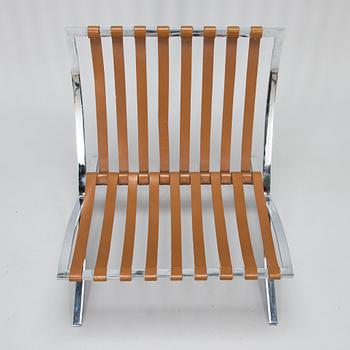 A Ludwig Mies van der Rohe "Barcelona" chair.