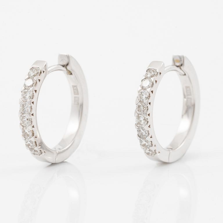 A pair of earrings in 18K white gold set with flander cut diamonds.