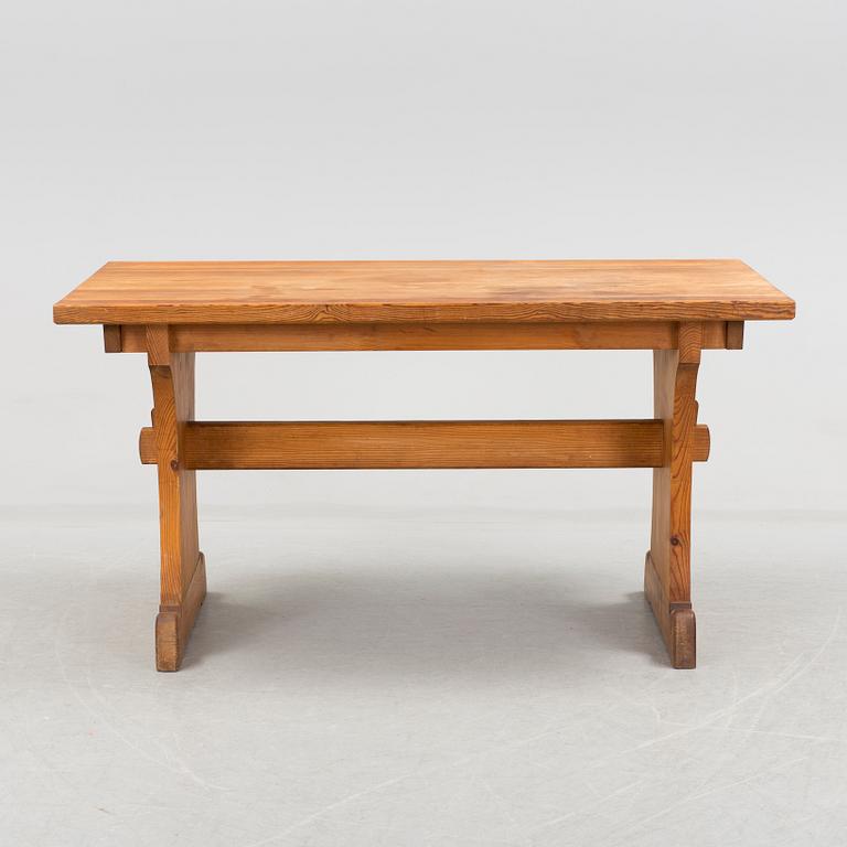 A solid pine table attributed to Axel Einar Hjort.