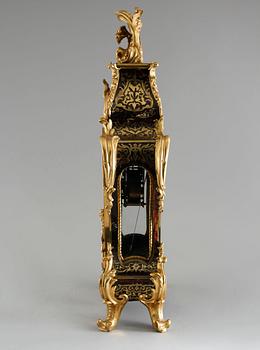 A 19th century mantle clock in the style of Louis XV.