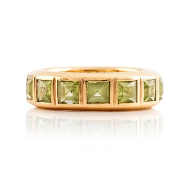 An 18K gold ring set with step-cut peridots.