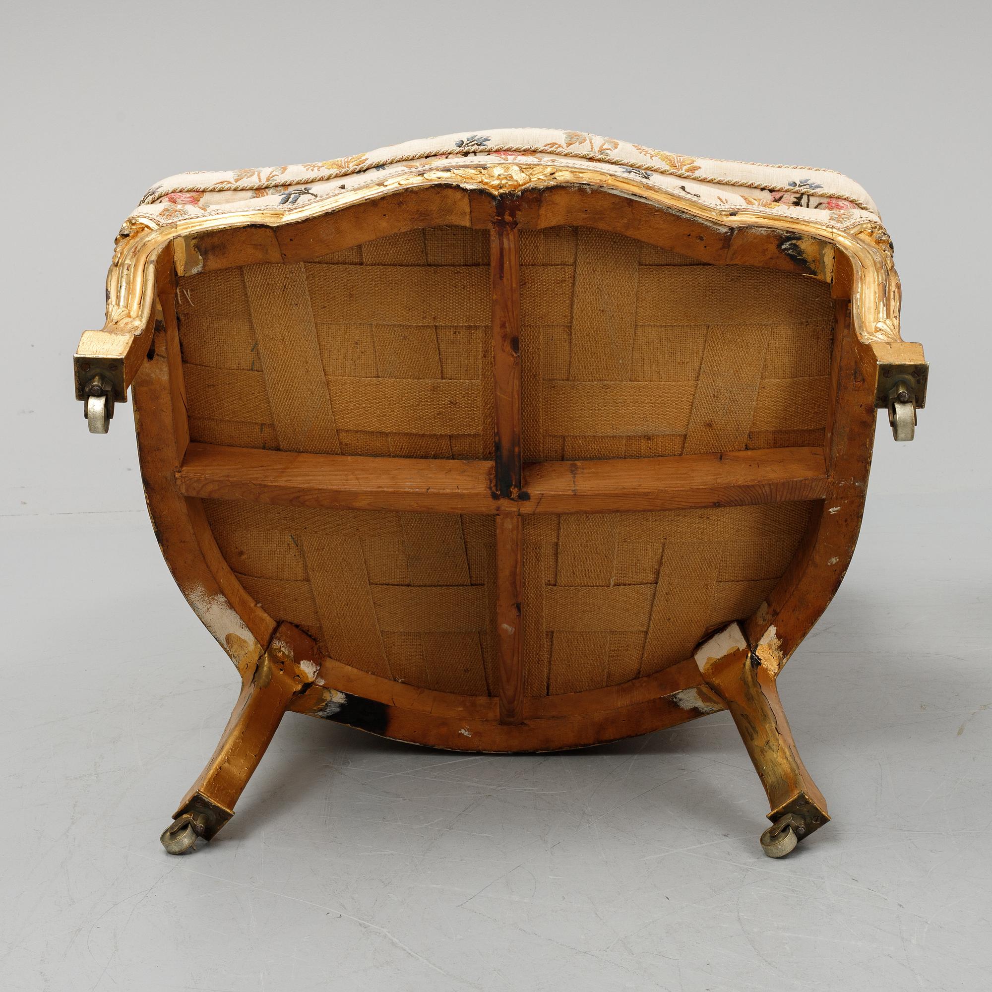 A Louis XV-style bergère armchair with stool, second half of the 19th century.