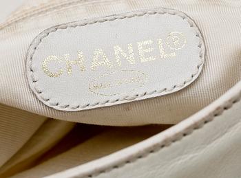 A white leather handbag by Chanel.