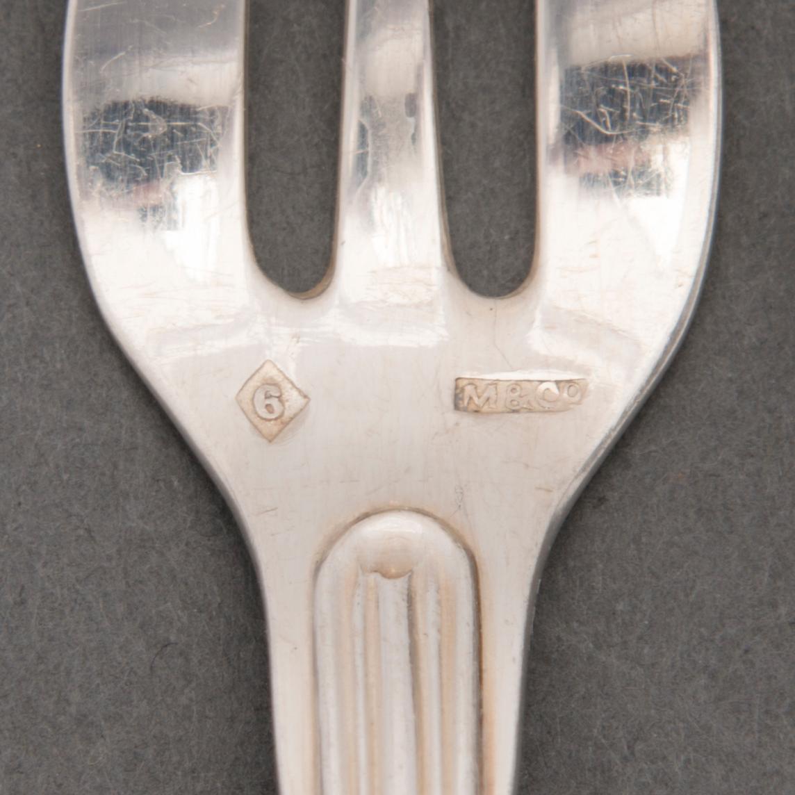 A SET OF 12 OYSTER FORKS, plate. Miele & Co.