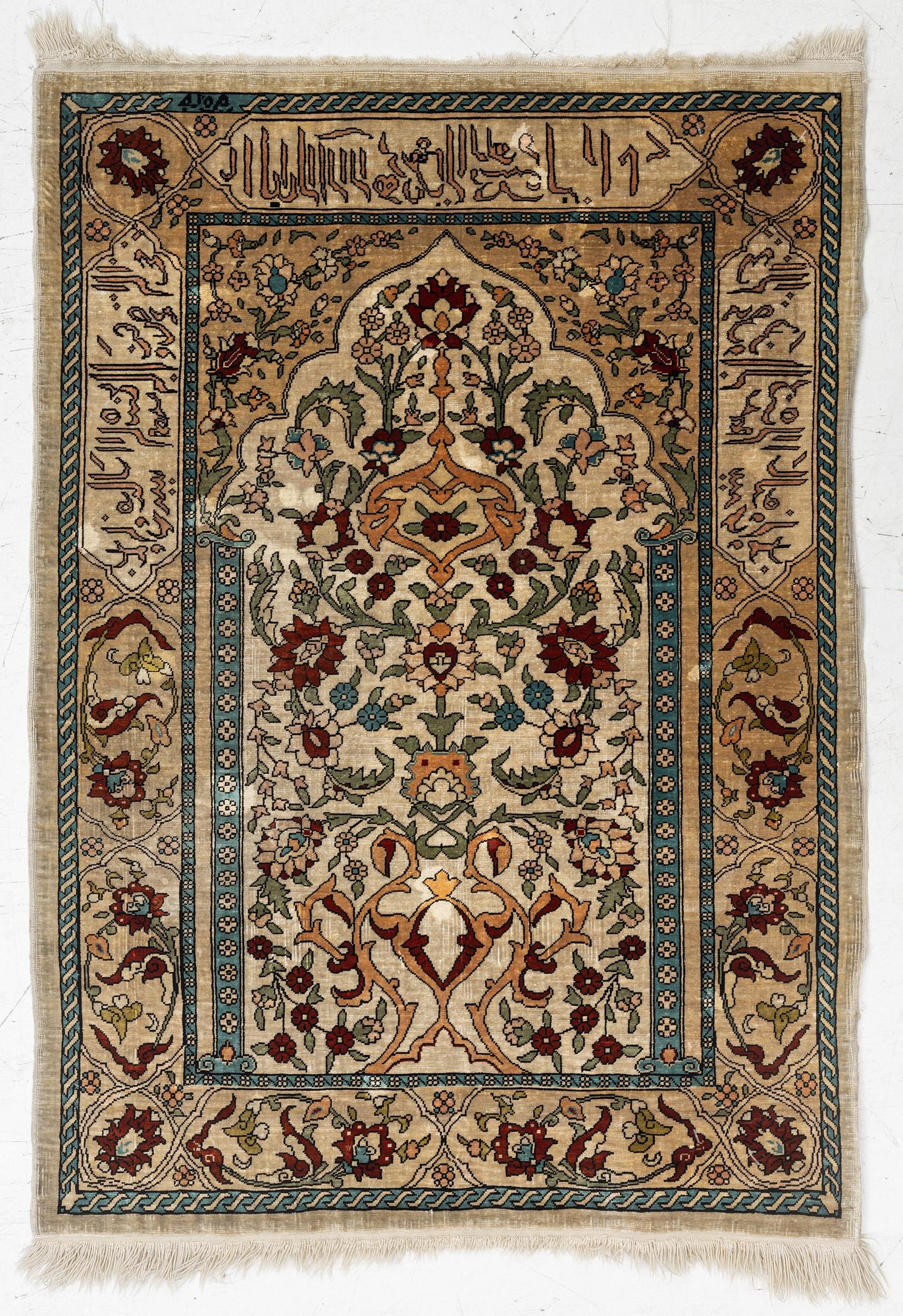 A Hereke silk rug, c. 73 x 52 cm.