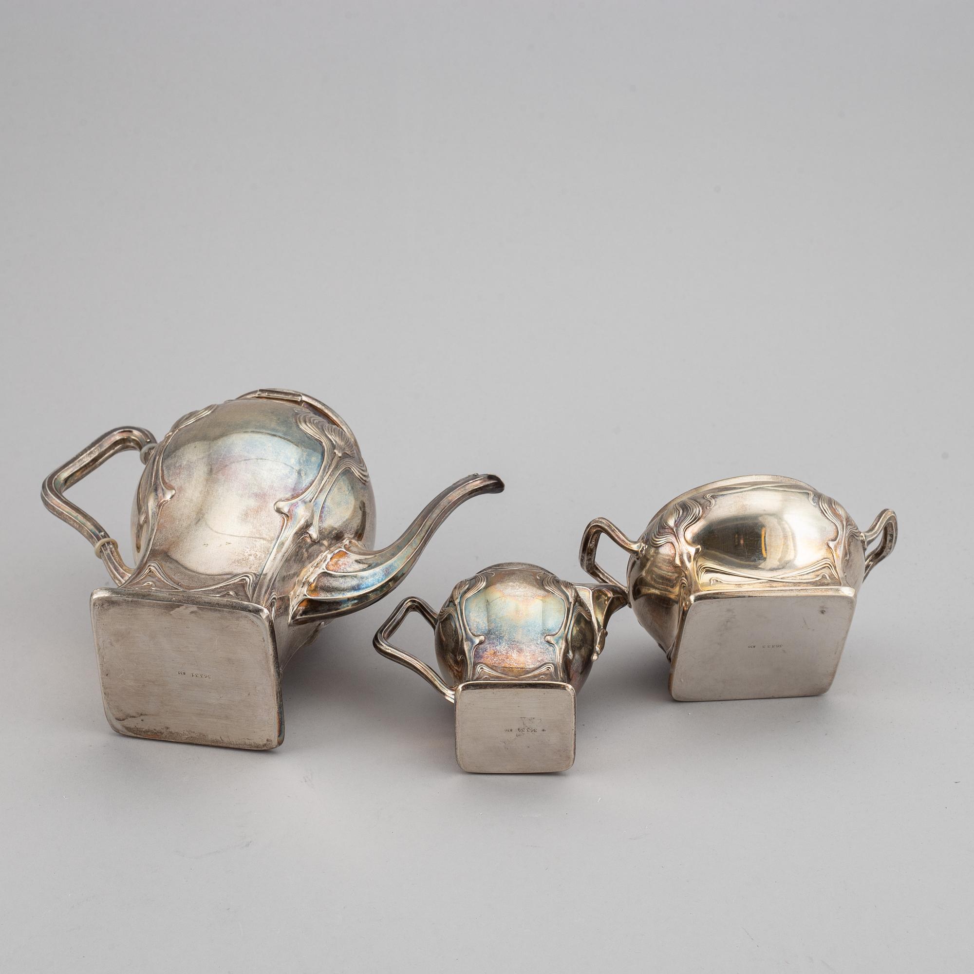 An art nouveau silver coffee pot, sugar bowl and creamer, mark of CF Källström, Malmö 1901.