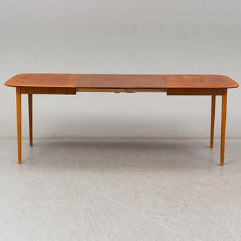 A late 20th Century teak veneered dinner table.