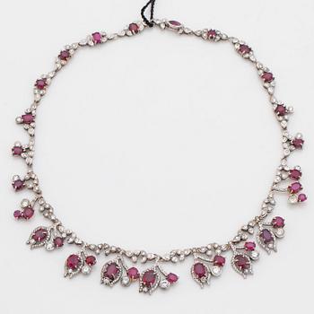 A 23.88ct ruby and brilliant cut diamond necklace. Total carat weight of diamonds 8.00cts. Mandelstam 'Stardust galaxy'.