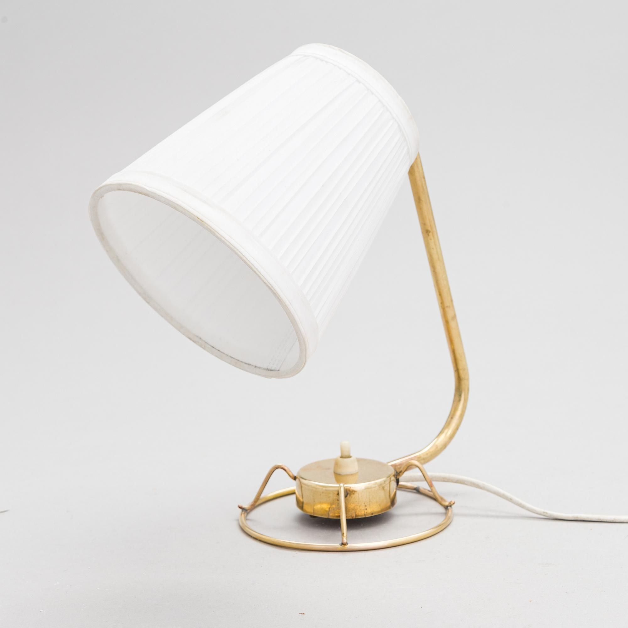 A mid-20th-century table lamp
/wall light for Idman.