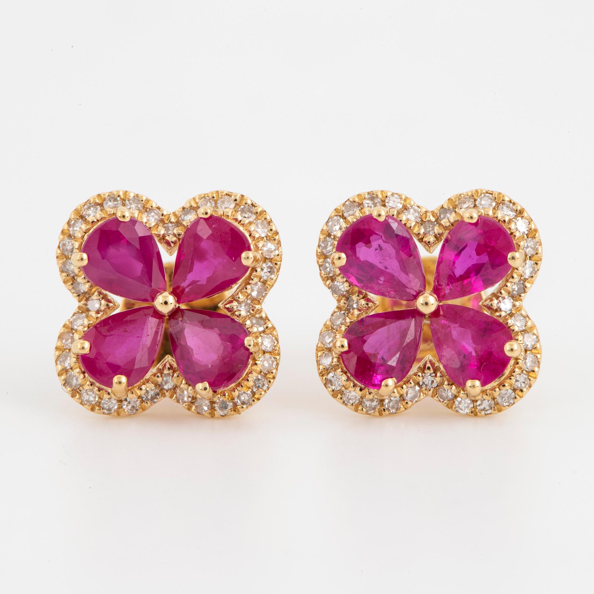 Pear shaped rubies and eight cut diamond flower earrings.