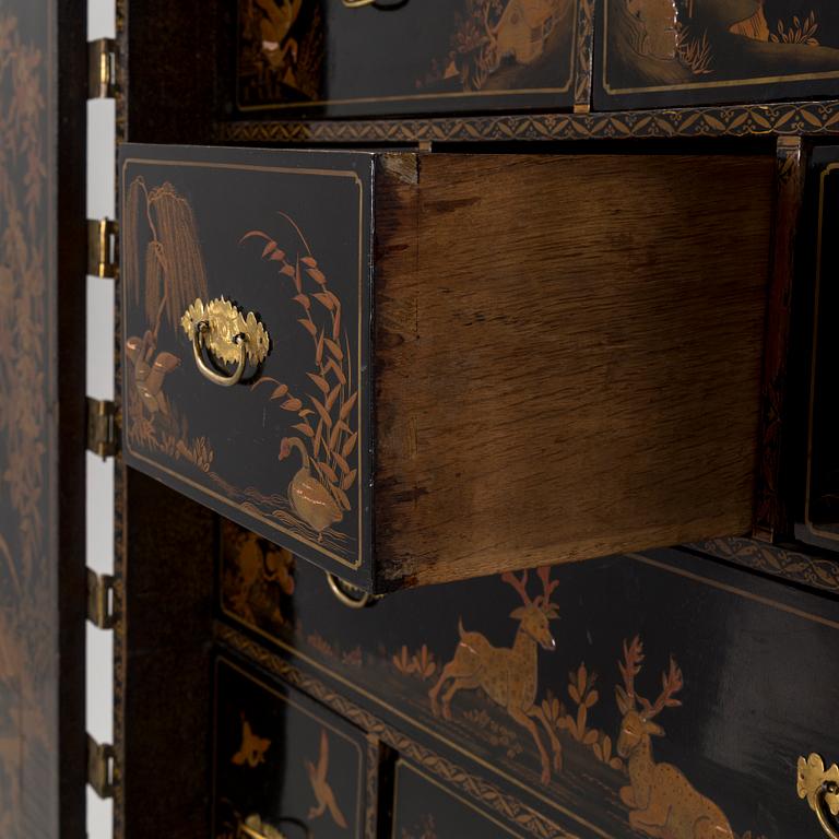 AN early 18TH CENTURY PROBABLY ENGLISH Japanned laquer cabinet on stand.