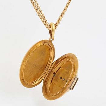 An 18K gold locket set with rose-cut diamonds.