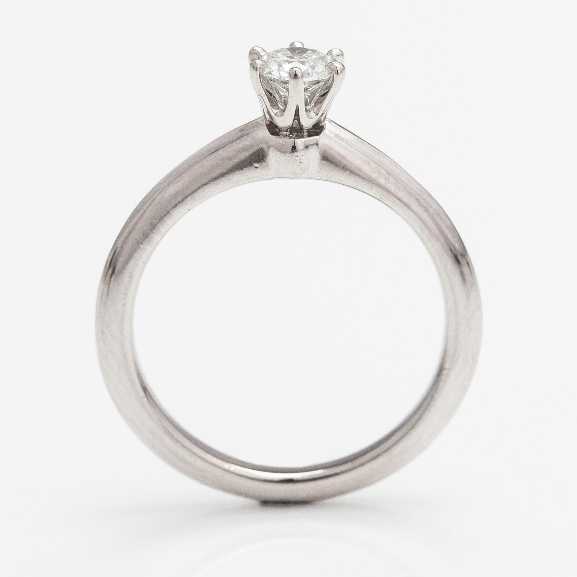 Tiffany & Co, A platinum ring with a ca. 0.26 ct diamond.