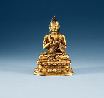1297. A gilt copper Buddha, presumably Qing dynasty, with Qian Long seven character mark.