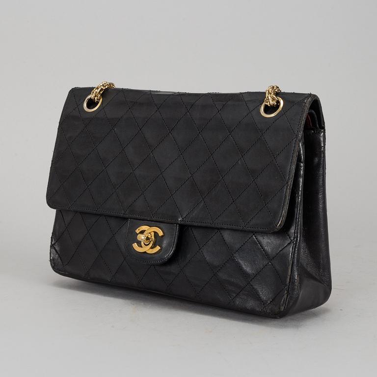 CHANEL, a quilted black leather 'Double Flap Bag'.