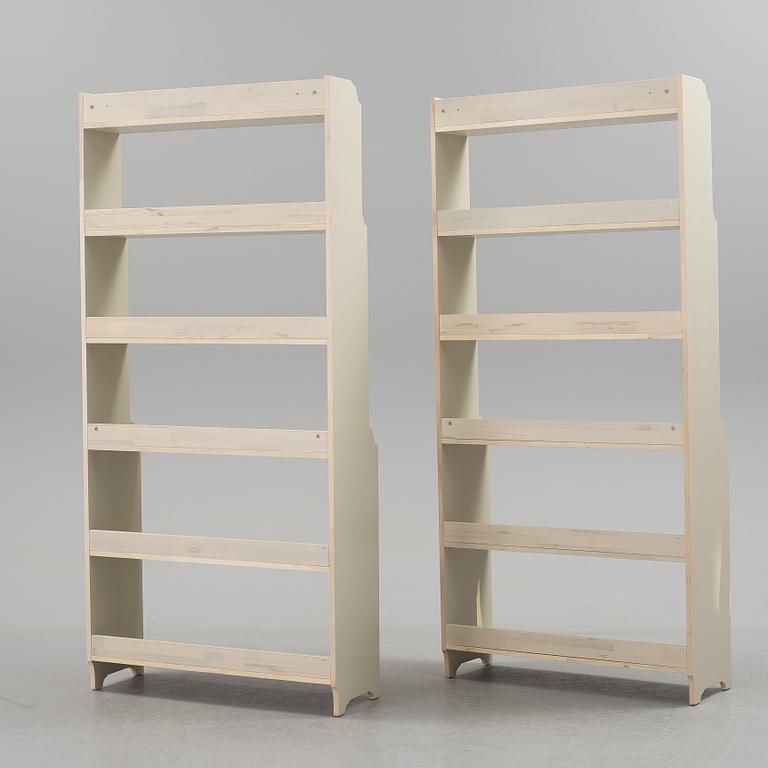 A pair of IKEA "Leksvik" painted bookcases.