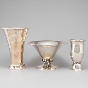 Two silver beakers and a bowl.