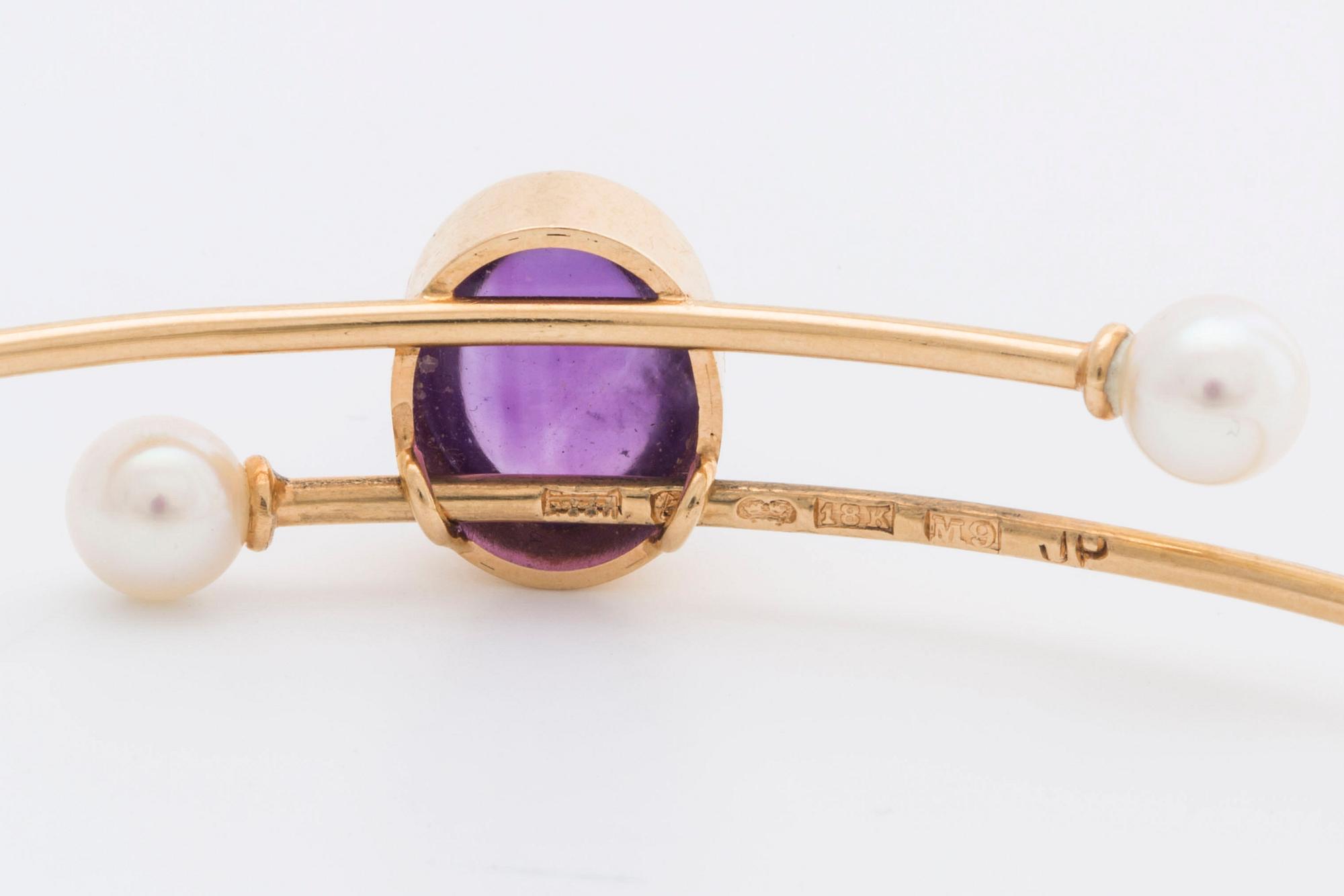 ARMRING 18K guld med 1 cabochon-slipad ametist ca 11 x 7 mm samt 2 odlade pärlor ca 5 mm, 1962.