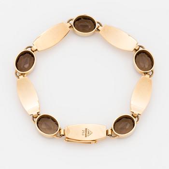 A Just Andersen 18K gold and smoky quartz bracelet.