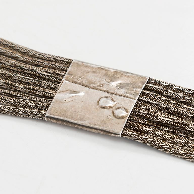 A silver belt, unidentified maker's mark.