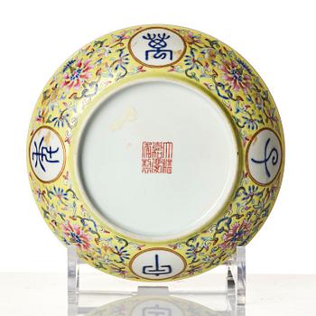 A yellow-ground famille rose 'lotus' dish, Qing dynasty, Jiaqing red seal mark and of the period (1796-1820).