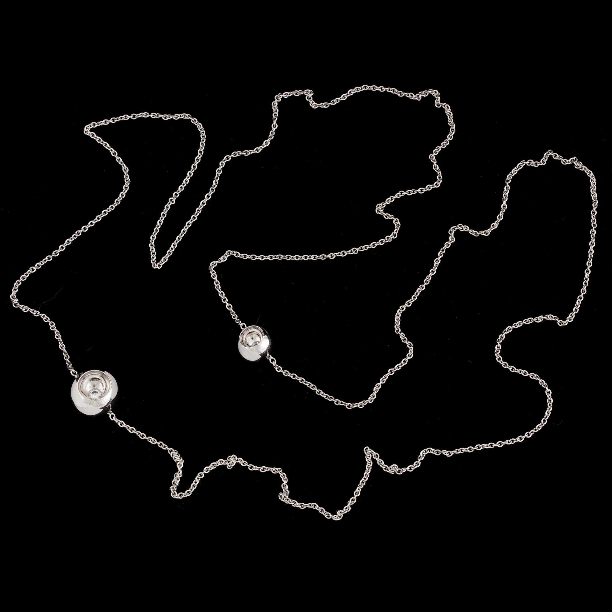 An 18K white gold 'Cave' necklace set with two round, brilliant-cut diamonds by Jacqueline Rabun for Georg Jensen.