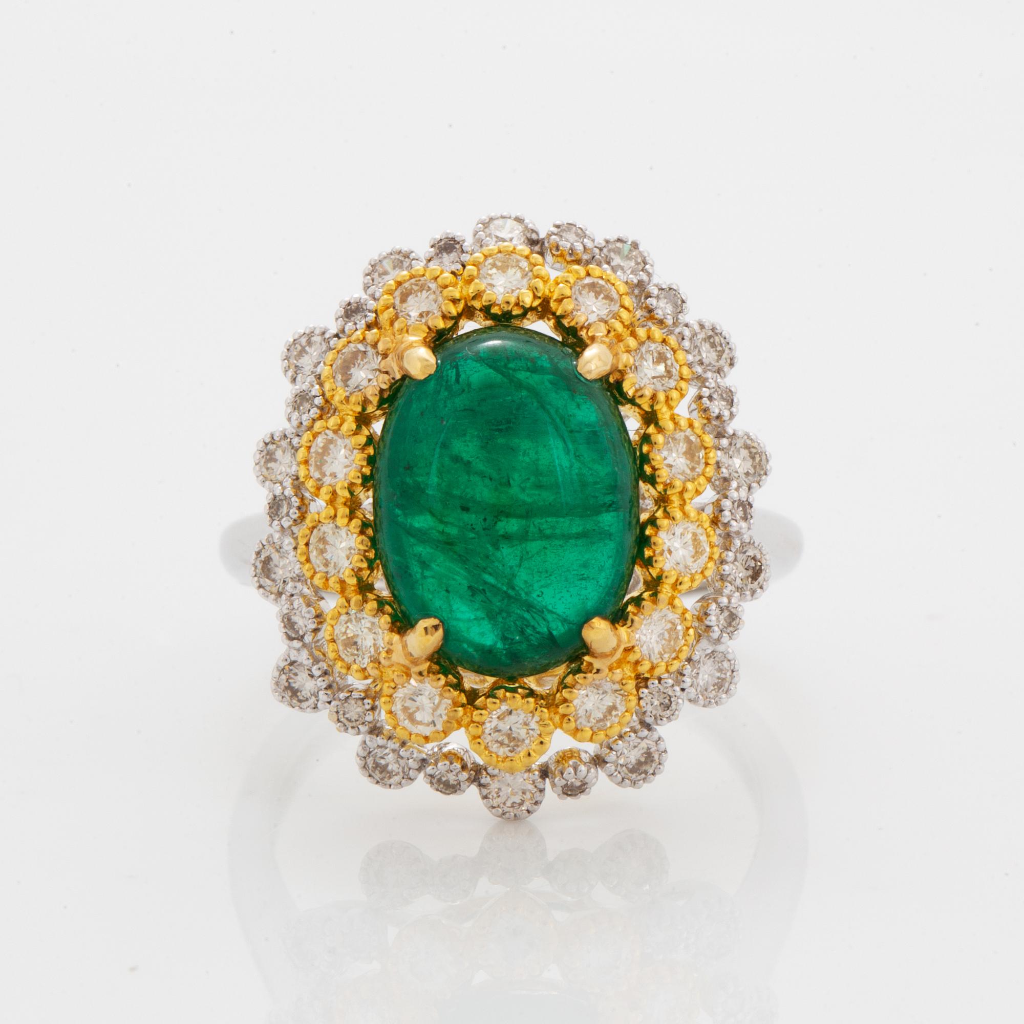 Cabochon-cut emerald and brilliant-cut diamond ring.