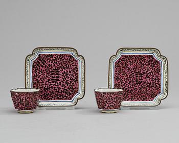 A pair of enamel on copper cups and saucers, Qing dynasty 18th century.