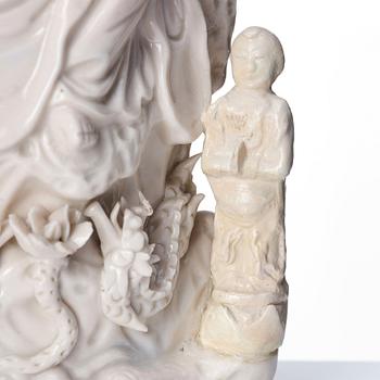 A Chinese blanc de chine Guanyin with attendants, Dehua, late Ming dynasty/early Qing dynasty.