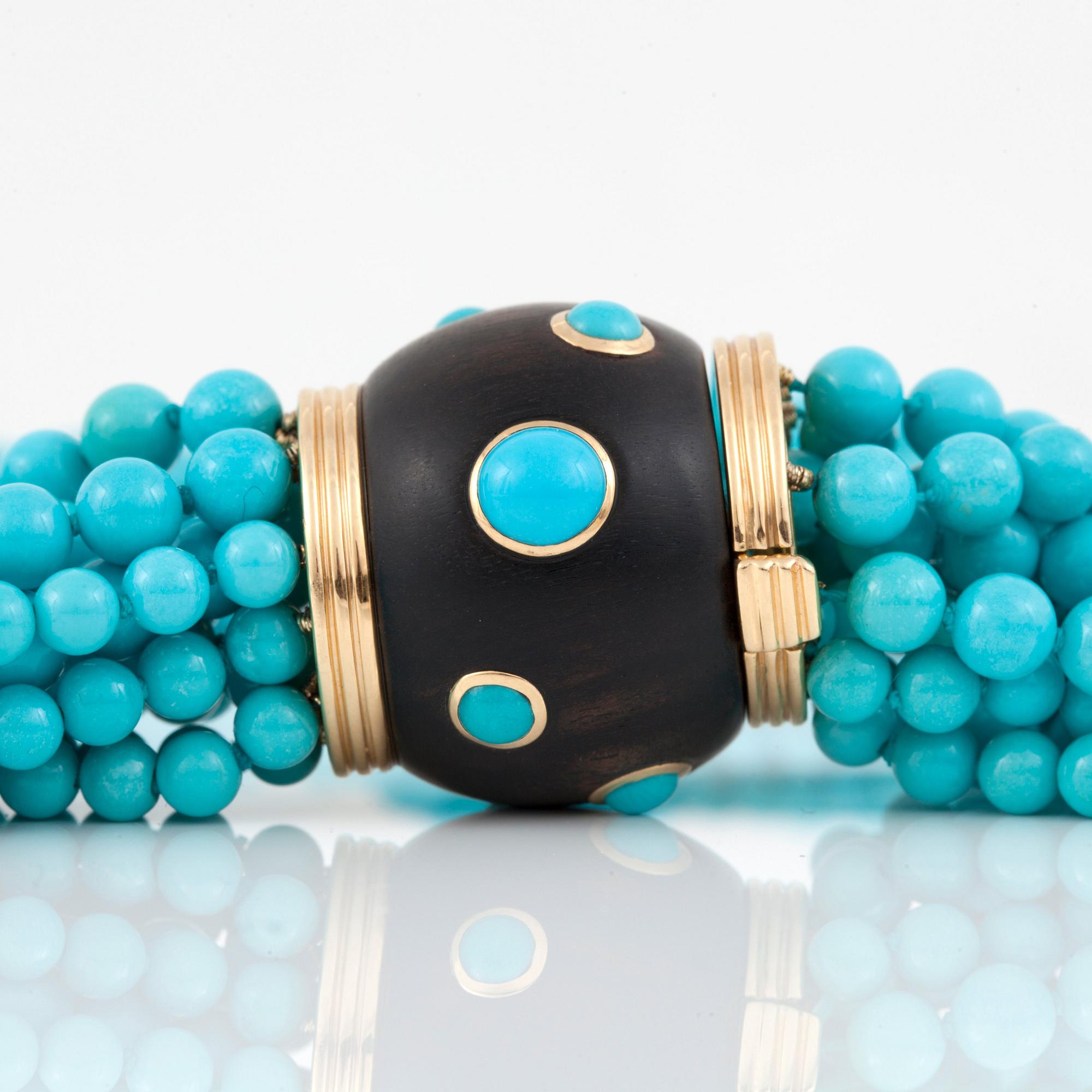 A 12-strand turquoise and wood necklace signed Trianon.