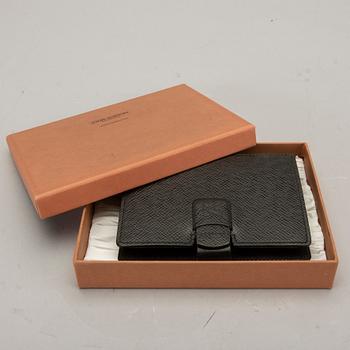 A Louis Vuitton palm pilot leather cover.