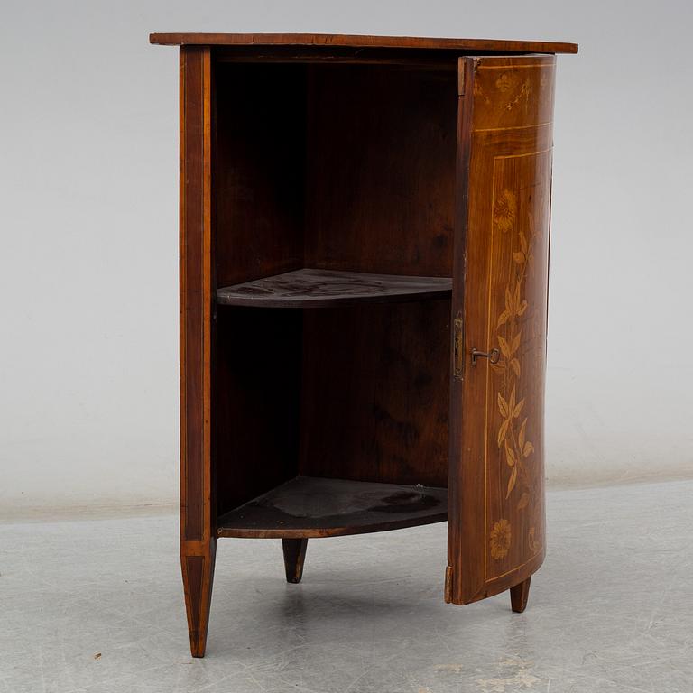 A 19th century corner cabinet.