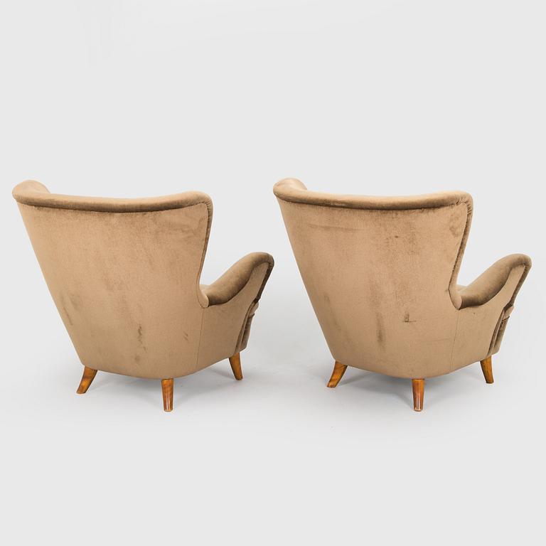 A pair of mid-20th century armchairs.