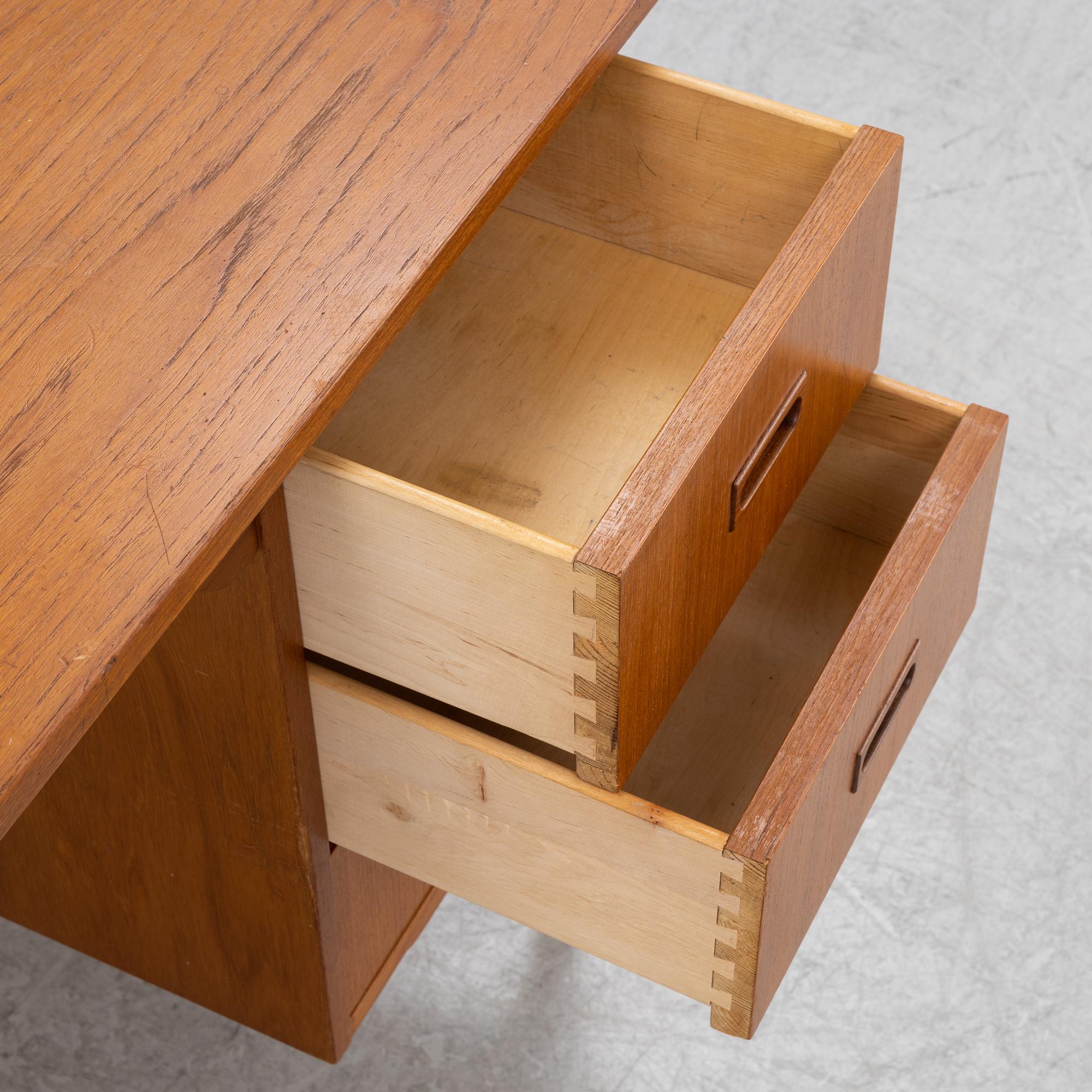 A teak veneered desk, mid 20th Century.