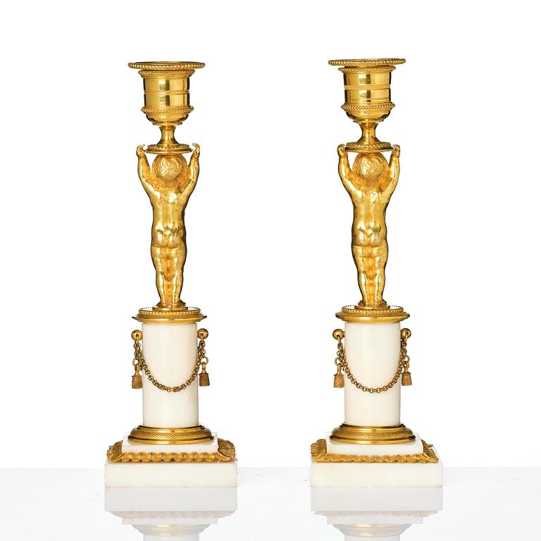 A pair of late Gustavian ormolu and white marble candlesticks, Stockholm, late 18th century.