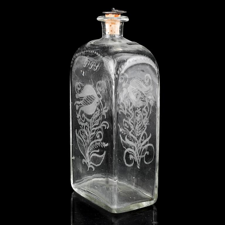 A glass bottle and three vodka glasses, 19th Century.
