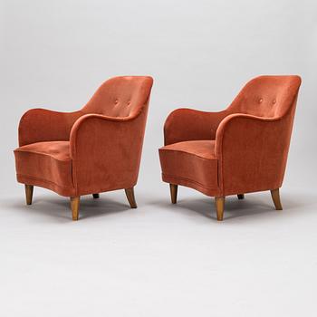 A pair of mid-20th-century armchairs.