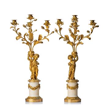 111. A pair of Louis XVI four light candelabra.