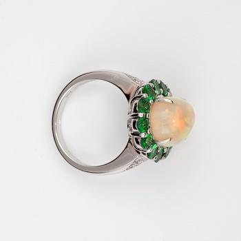 An Ethiopian opal, diamond and tsavorite ring.