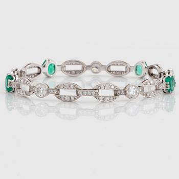 An 18K white gold bracelet set with faceted emeralds.