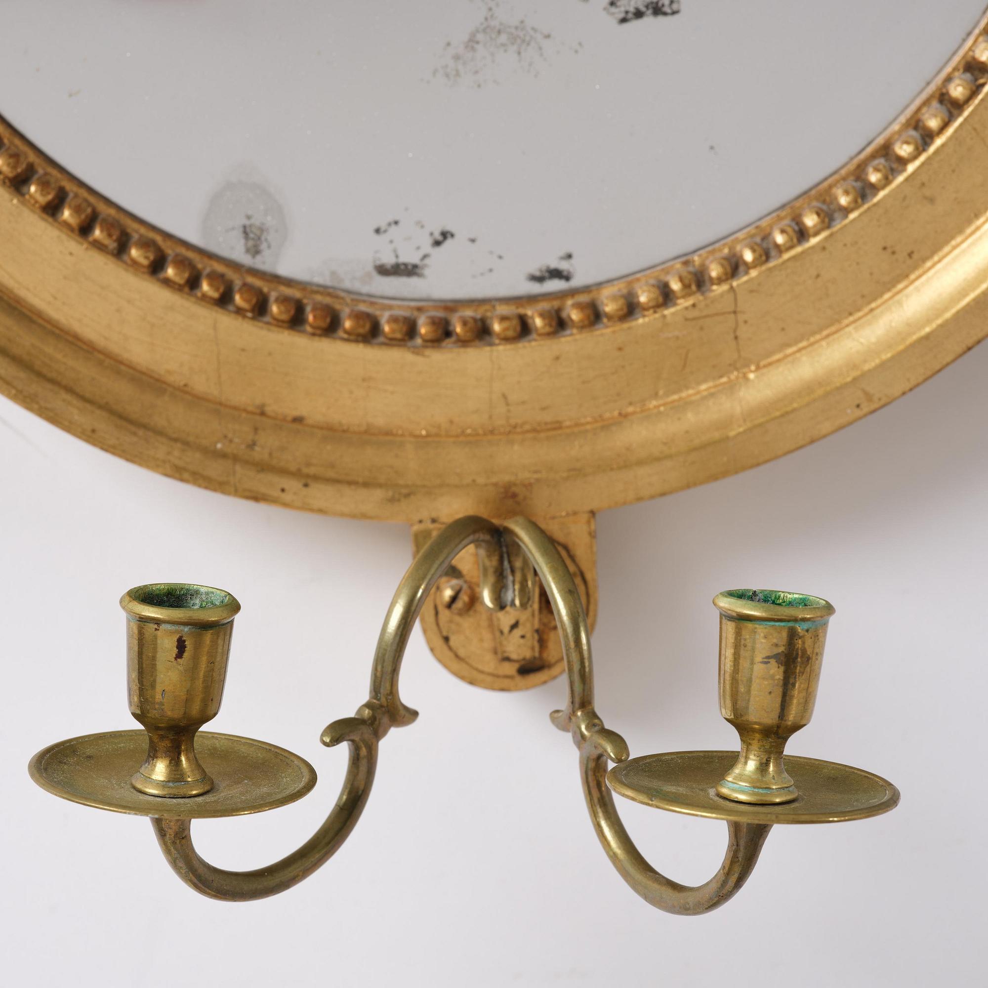 A pair of Gustavian giltwood two-branch girandole mirrors by J. Åkerblad (master in Stockholm 1758-99).