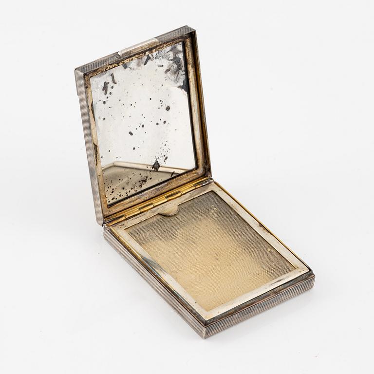 Powder box, signed Cartier, sterling silver and 14K gold with three sapphires.