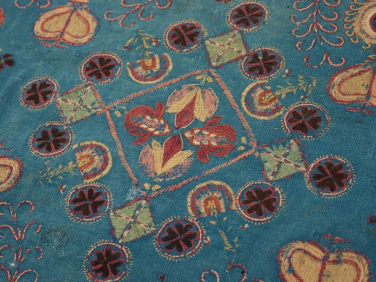 A CARRIAGE CUSHION, embroidered. "Blomsterdyna". 54 x 110 cm. Skåne (Scania, southern part of Sweden) around 1800.