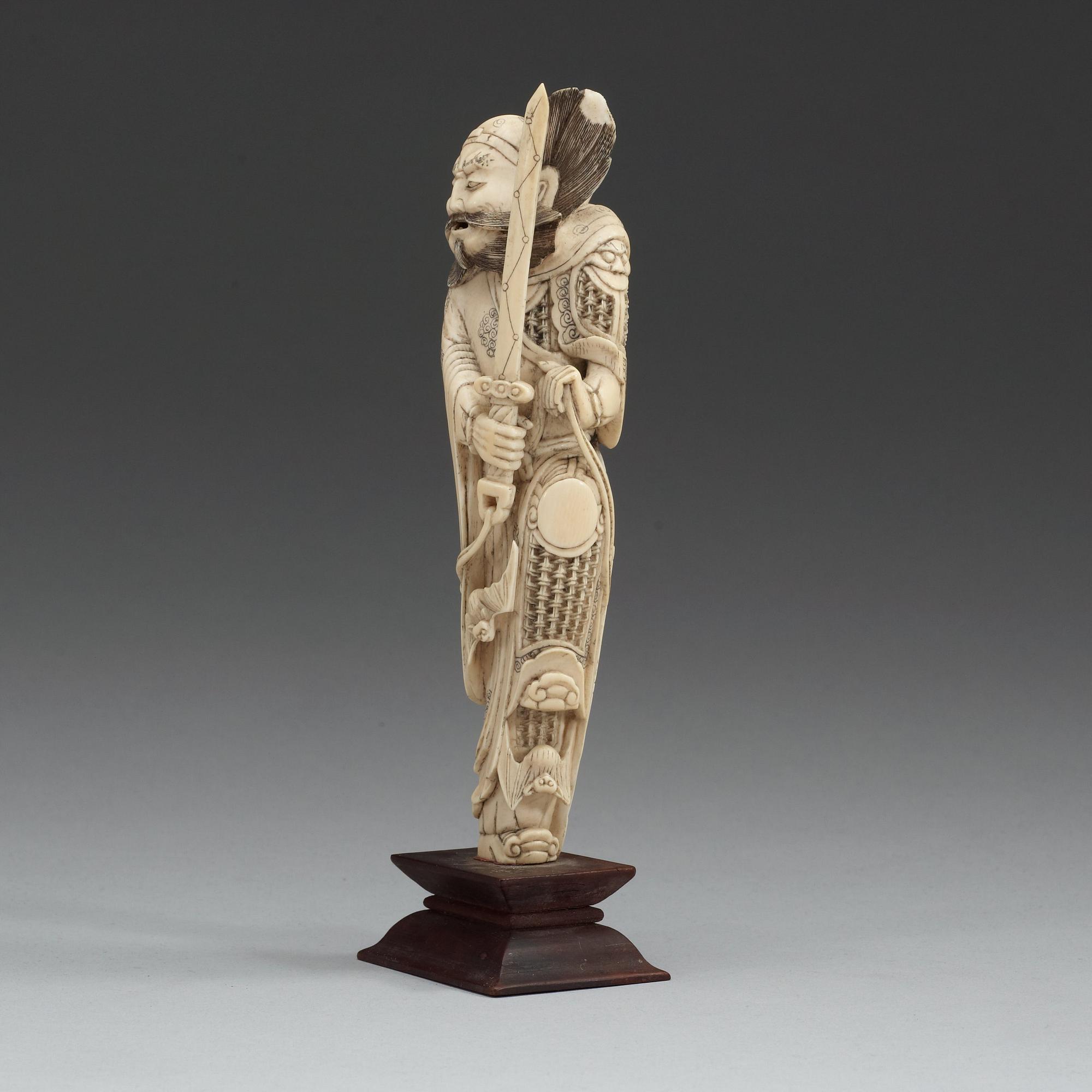 An carved ivory sculpture of a guardsman, China, early 20th Century.