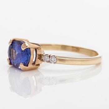 A 14K gold ring, with a tanzanite and diamonds totalling approximately 0.08 ct.