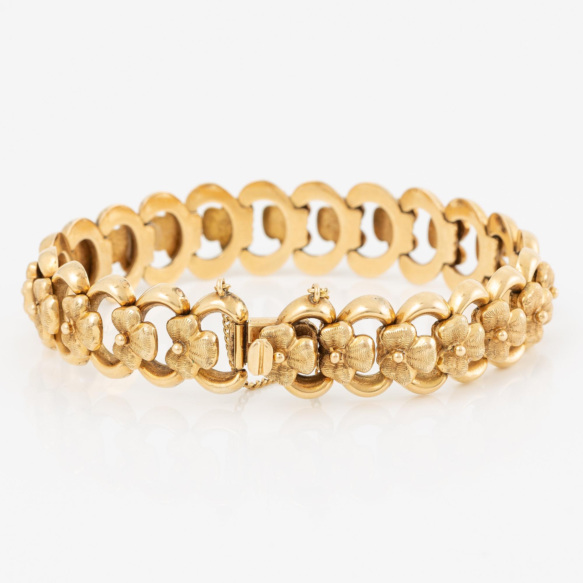 Arm bracelet, 18K gold, decoration of flowers.