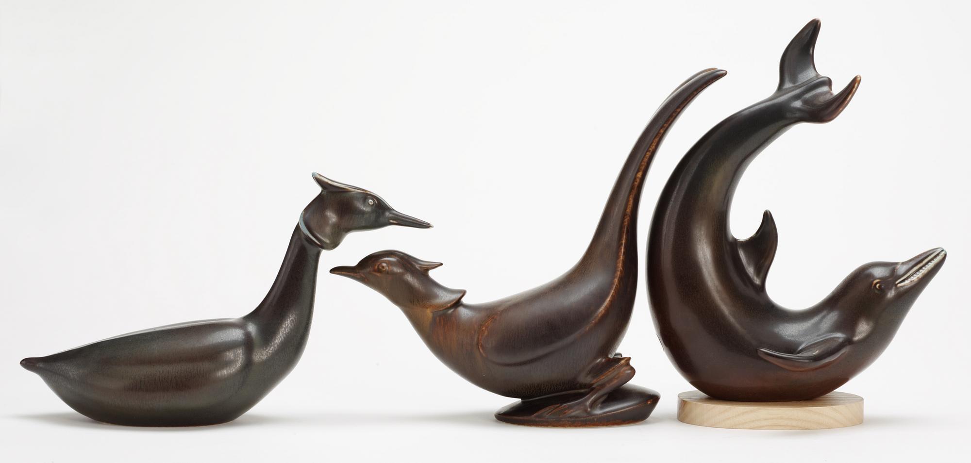 Three Gunnar Nylund stoneware figures, a dolphin, a pheasant and a great crested grebe, Rörstrand.